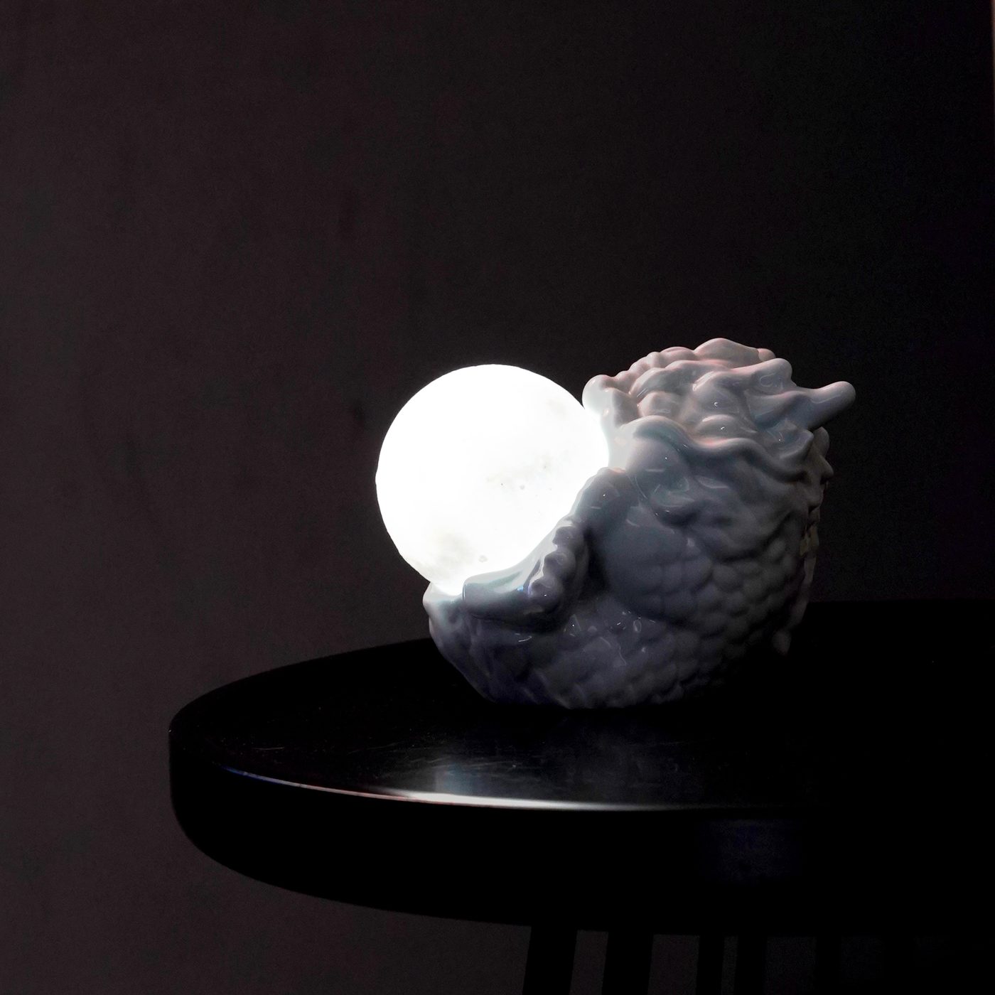 Cerqora dragon and pearl ceramic moon lamp, softly lit on a bedside table